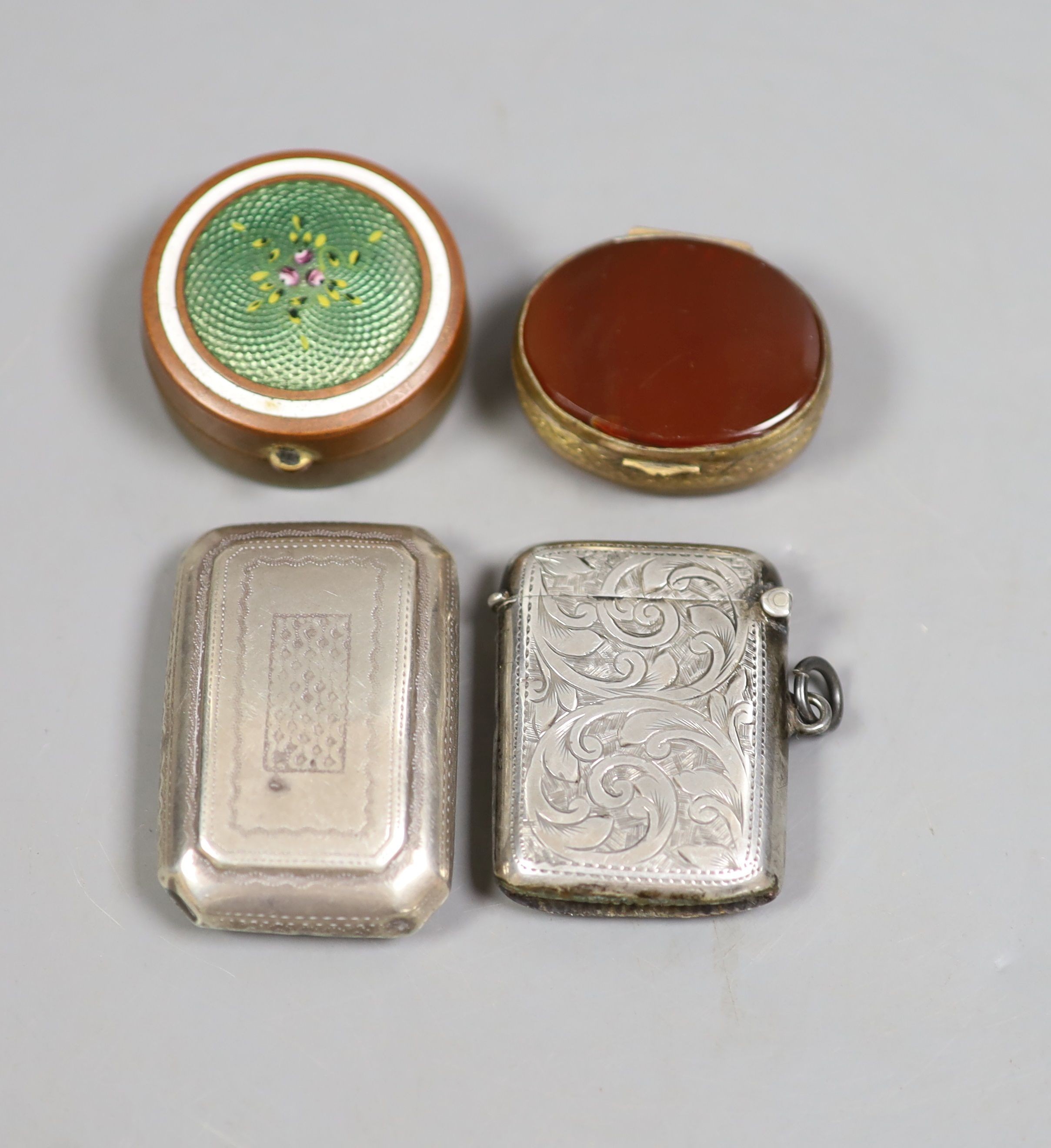 A George III silver curved snuff box, Birmingham, 1813, 52mm, a silver vesta case and two metal pill boxes